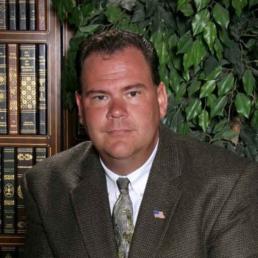 Photo of County Judge Mark Allen in a law library.